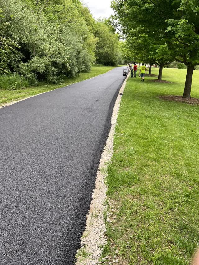 Freshly paved path with the crew finishing up